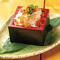 Extravagant pressed masuzushi sushi dish of sea urchin, crab, and salted salmon roe